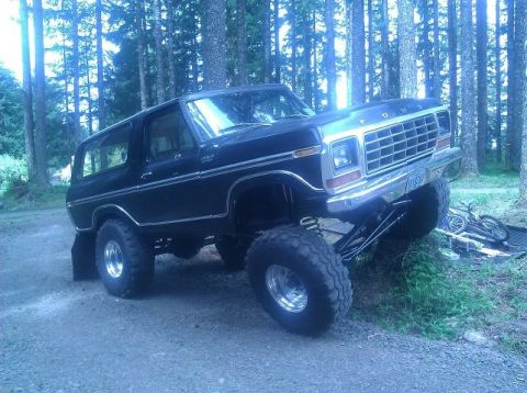 1979 Ford Bronco - This lifted 1979 Ford Bronco is parked off-road with a bicycle visible in the background.