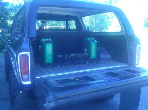1979 Ford Bronco - Rear view of a 1978 Ford Bronco showing fuel cans and storage in the cargo area.