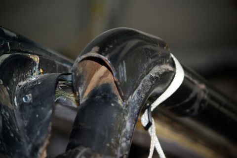 1995 Ford Bronco - Detail of a roll bar connection point, showing wear and a white rope attachment.