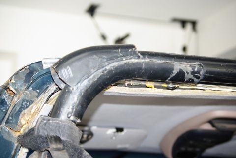 1995 Ford Bronco - Close-up view of a damaged roll bar and surrounding interior components.