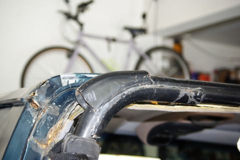 1995 Ford Bronco - The vehicle's frame shows significant rust damage around the roll bar mounting point.