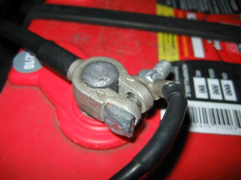 1992 Ford Bronco - Car battery terminal connection with a black cable attached to the clamp.