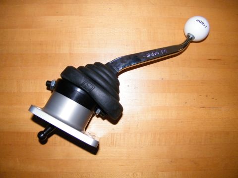 2004 Ford Crown Victoria - A Hurst shifter assembly with a white shift knob is shown on a wooden surface.
