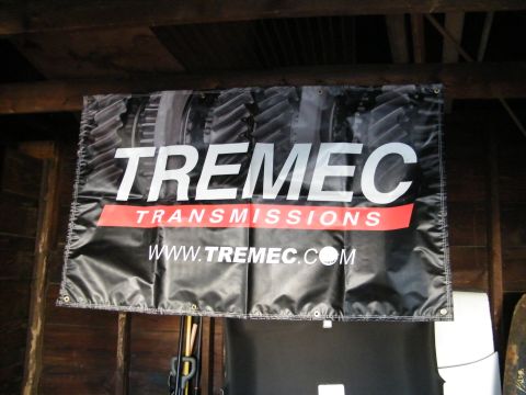 2004 Ford Crown Victoria - A banner for TREMEC TRANSMISSIONS hangs from a wooden ceiling.