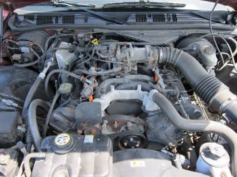 2001 Ford Crown Victoria - The engine bay of a 2001 Ford Crown Victoria is visible, with various components and hoses.