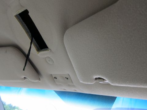 2001 Ford Crown Victoria - Interior view of a car's headliner, showing a gap with wires and two sun visors.