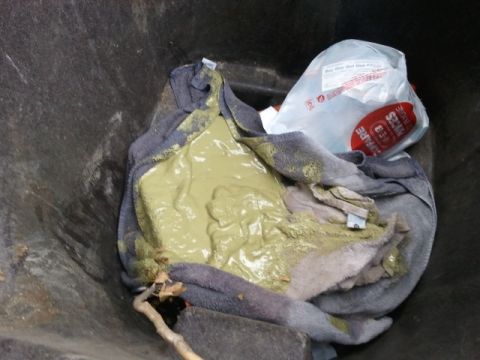 2004 Ford F-350 - A trash can contains towels and a green substance, with a plastic bag partially visible.