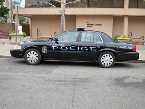1991 Ford LTD Crown Victoria - black Thurmont Police Ford Crown Victoria with white and blue lettering parked along a curb.