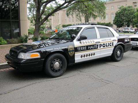 1991 Ford LTD Crown Victoria - Front-quarter view of a black-and-white Terre Haute Police Ford Crown Victoria cruiser parked on a downtown street.