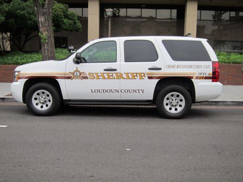 1991 Ford LTD Crown Victoria - white Chevrolet Tahoe SUV lettered Loudoun County Sheriff Crash Reconstruction Unit parked on a street.