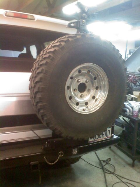 1996 Ford Bronco - A large spare tire is mounted on a custom rear bumper, obscuring most of the vehicle.