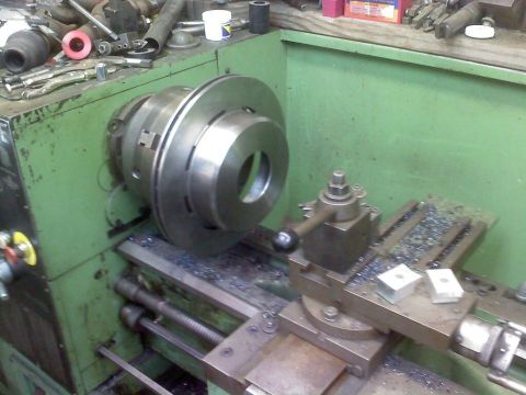 1996 Ford Bronco - Machining a brake rotor on a metal lathe in a workshop.