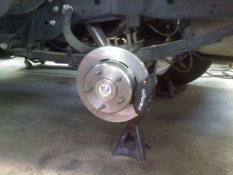 1996 Ford Bronco - The rear brake system of a vehicle is shown, a new rotor and Wilwood caliper.