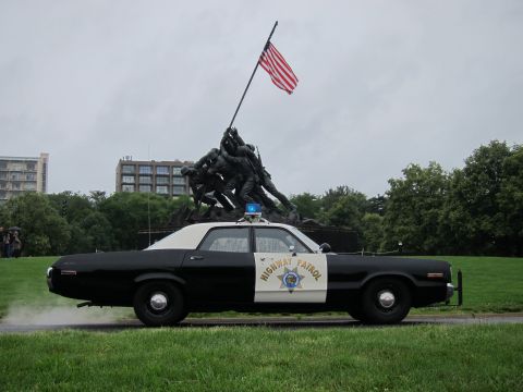 1991 Ford LTD Crown Victoria - Side view of a black-and-white Highway Patrol sedan with exhaust smoke at the Iwo Jima Marine Corps War Memorial.