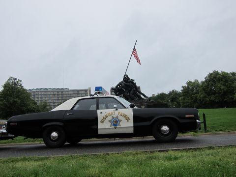 1991 Ford LTD Crown Victoria - Side view of a classic black-and-white Highway Patrol sedan with door shield parked before the Iwo Jima War Memorial.