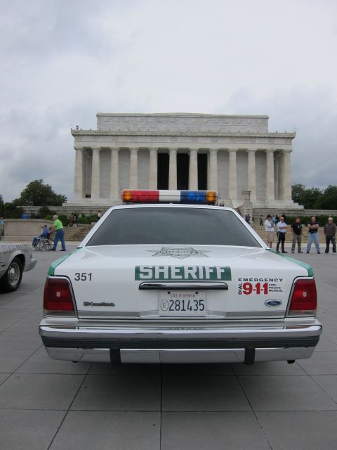 1991 Ford LTD Crown Victoria - Rear view of a green-and-white SHERIFF Ford Crown Victoria with light bar parked in front of the Lincoln Memorial.