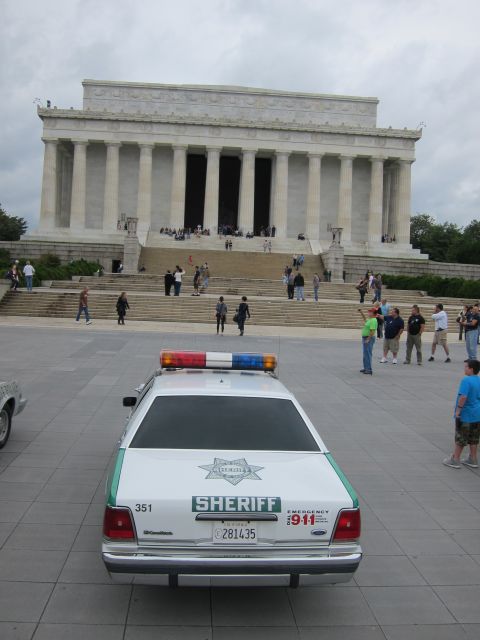 1991 Ford LTD Crown Victoria - Rear view of a green-and-white SHERIFF Crown Victoria parked facing the Lincoln Memorial steps.