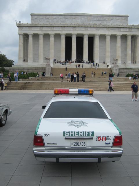 1991 Ford LTD Crown Victoria - Rear view of a green-and-white SHERIFF Ford Crown Victoria with light bar parked before the Lincoln Memorial.