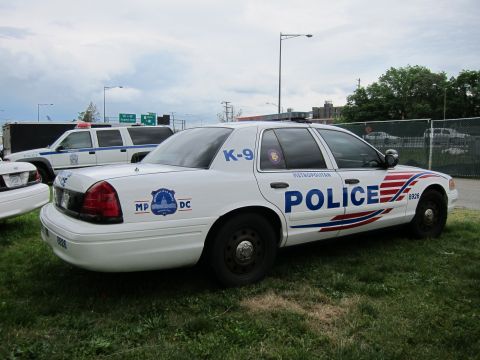 1991 Ford LTD Crown Victoria - white Ford Crown Victoria Metropolitan Police K-9 sedan parked on grass beside other patrol cars.
