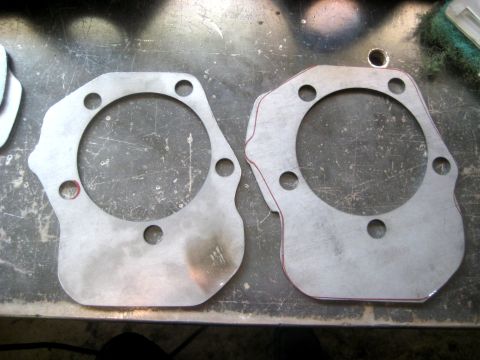 1996 Ford Bronco - Two custom-cut metal gaskets are shown on a workbench surface.