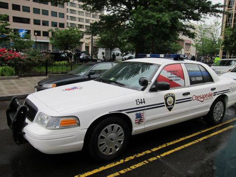 1991 Ford LTD Crown Victoria - white Chesapeake Virginia police sedan with a fallen-officer memorial decal on the rear window, parked on a street.