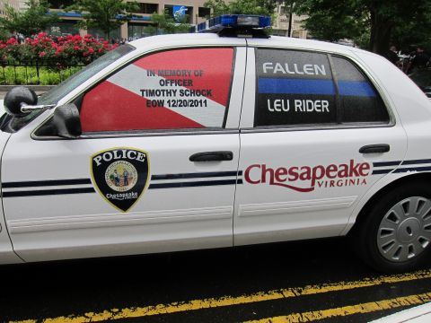 1991 Ford LTD Crown Victoria - close-up of a Chesapeake Virginia police car showing the door badge and a fallen-officer memorial window decal.