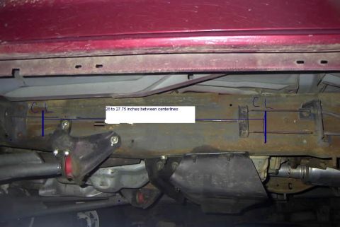 1994 Ford Bronco - Close-up view of a vehicle's undercarriage, highlighting frame measurements and rust.