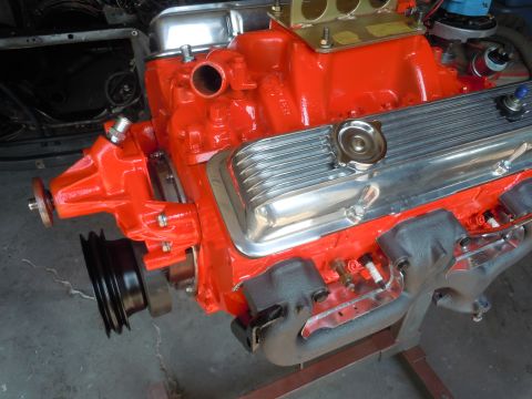 1973 Chevrolet Camaro - A close-up view of a freshly painted V8 engine, likely undergoing restoration or rebuild.