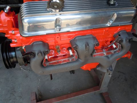 1973 Chevrolet Camaro - Close-up view of an engine's internal components, including the block, valve covers, and exhaust manifolds.