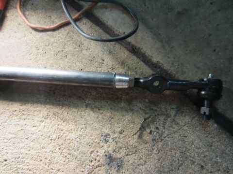 1992 Ford Bronco - A close-up view of a vehicle's steering linkage rod assembly.