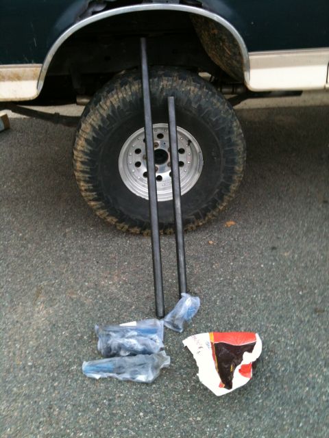 1992 Ford Bronco - Steering components laid out next to the wheel well of a 1992 Ford Bronco.