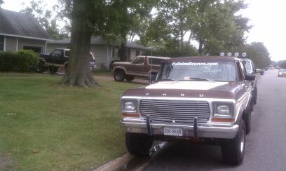 1992 Ford Bronco - Two Ford trucks and a Bronco parked on a residential street.