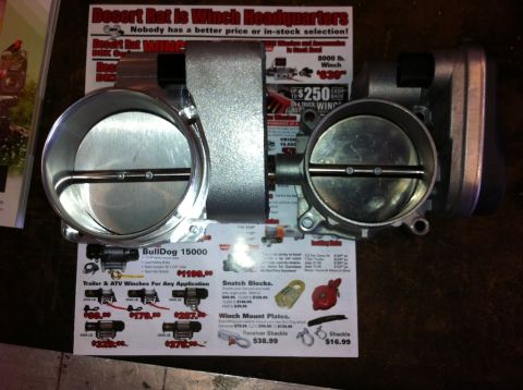 2010 Dodge Challenger - Two throttle bodies are shown with a flyer advertising winches and related accessories.