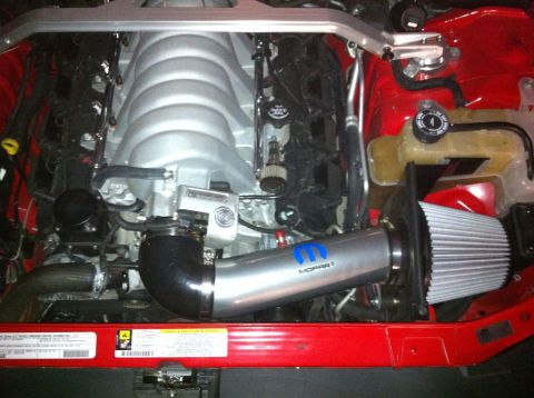 2010 Dodge Challenger - Close-up view of a Mopar cold air intake system installed in a vehicle's engine bay.