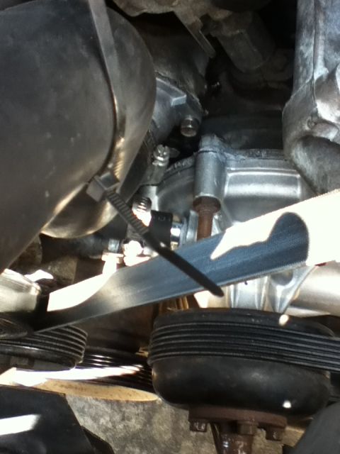 1994 Ford Bronco - Close-up view of a vehicle's water pump and serpentine belt system.