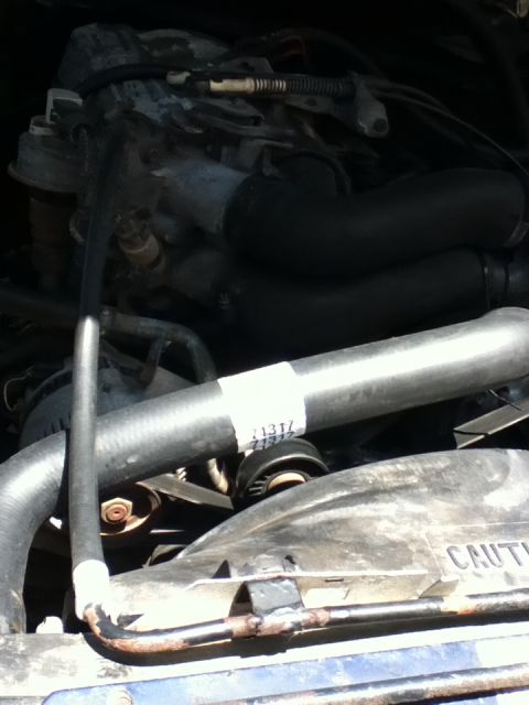 1994 Ford Bronco - Close-up view of an engine bay, showing various components and hoses.