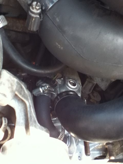 1994 Ford Bronco - Close-up view of an engine's water pump assembly, showing hoses and metal clamps.