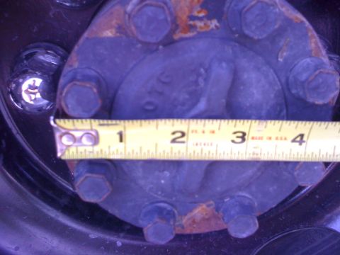 1997 Dodge 3500 - A measuring tape is placed against a wheel hub, indicating a measurement of around 3 inches.