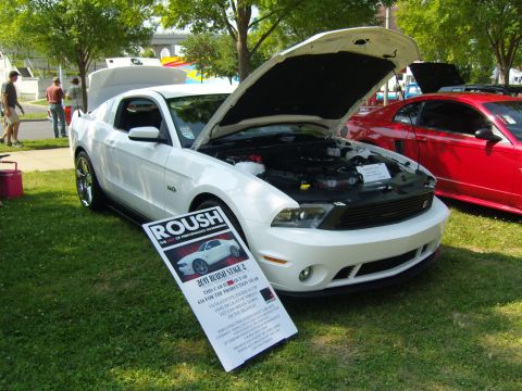 2007 Ford Mustang - A white 2011 Roush Stage 2 Mustang is displayed with its hood open at an outdoor car show.