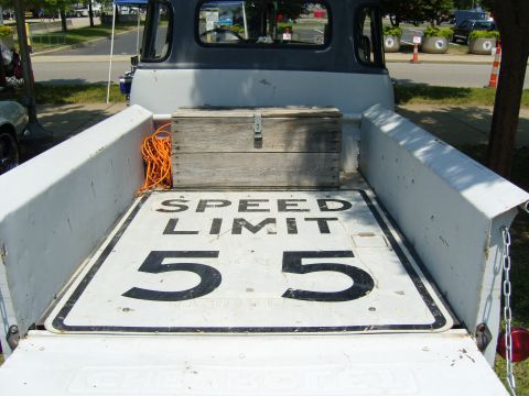 2007 Ford Mustang - The bed of an old pickup truck contains a wooden box, rope, and a "SPEED LIMIT 55" sign.