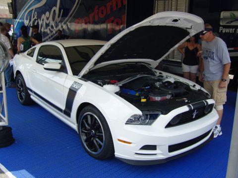 2007 Ford Mustang - White 2012 Ford Mustang Boss 302 displayed with its hood open, revealing the engine bay.