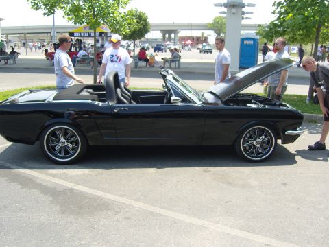2007 Ford Mustang - Classic black convertible with custom wheels and open hood at an outdoor event.