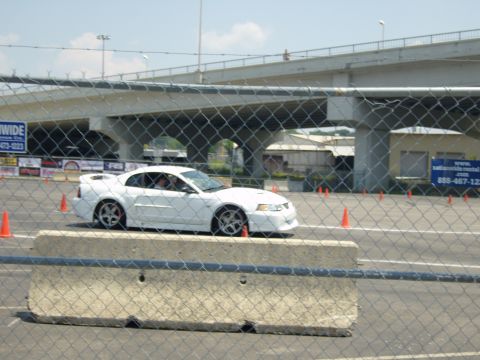 2007 Ford Mustang - White 2003 Ford Mustang Cobra navigates a course marked by orange cones.