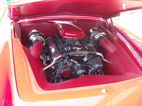 2007 Ford Mustang - Customized engine bay with a V8 engine and red accents, 'THUNDERBIRD' text on the fender.