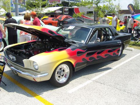 2007 Ford Mustang - A customized classic Mustang is displayed with its hood open, a flame paint scheme.