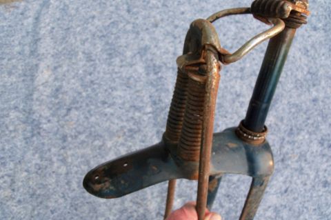 1994 Ford Bronco - This is a close-up of a rusty bicycle fork and handlebars, showing the springs and frame.