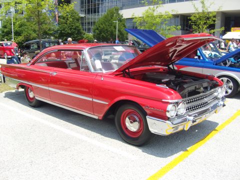 2007 Ford Mustang - A bright red 1960 Ford Fairlane 500 is displayed with its hood open, revealing the engine bay.