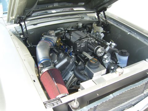 2007 Ford Mustang - The engine bay features a supercharged V8 with a large air intake and Ford SVT branding, suggesting a performance modification.