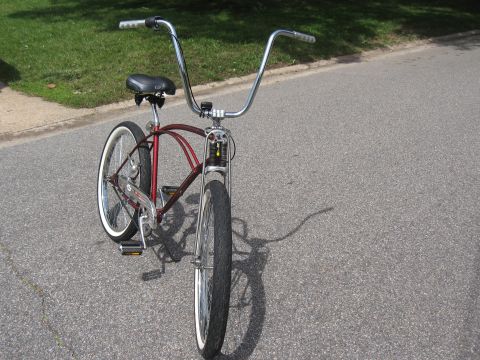 1994 Ford Bronco - Cruiser bicycle with tall handlebars and whitewall tires.
