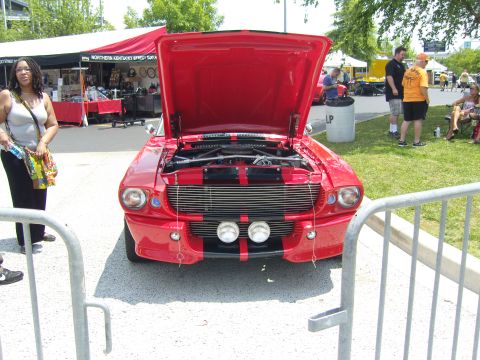 2007 Ford Mustang - Front view of a red classic car with its hood open, displaying the engine and grille details.